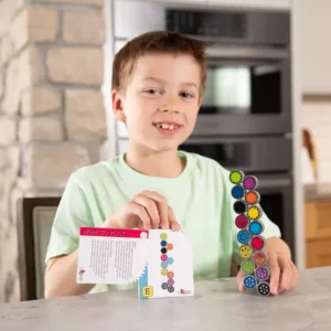 boy holds up coggy shown in the same configuration as shown on a page in the puzzle book