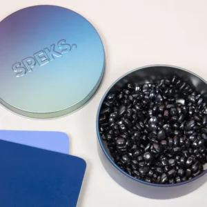 blue iridescent container with lid with black tiny magnets inside
