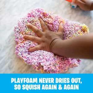 different colored playfoam mixed together with a child's hand pressed into the middle