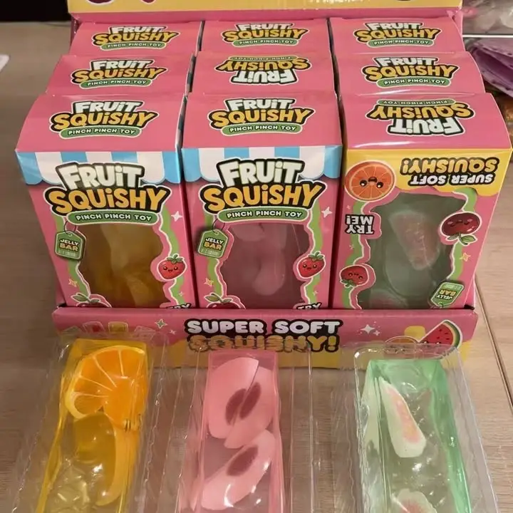 display case of fruit squishy toys with translucent colored cubes with oranges, peaches and apples inside